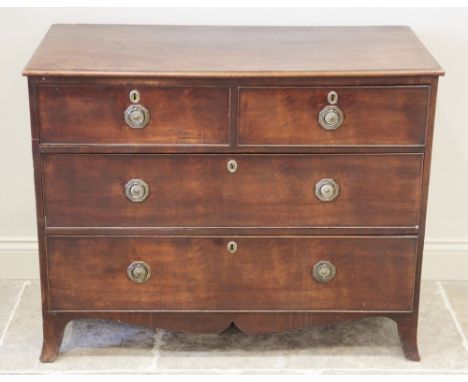 An early 19th century mahogany chest of drawers, the rectangular moulded top over two short and two long drawers, applied wit