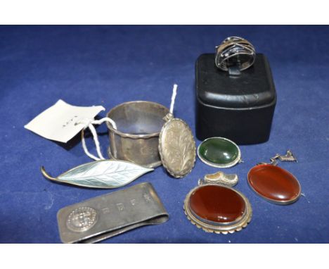 Silver items including: napkin ring, money clip, locket, and a Norwegian enamel leaf brooch by David Andersen.