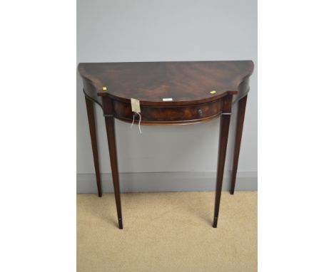 A reproduction mahogany console table with shaped front, fitted a single frieze drawer, bearing label "NH Chapman &amp; Co., 