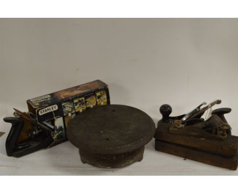 Three Stanley woodworking planes and a vintage cast iron revolving cake stand by Mathews Ltd.