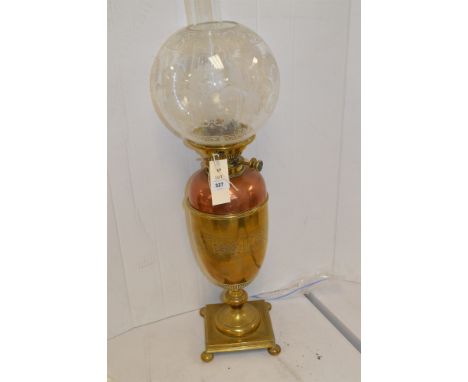 A late 19th Century brass duplex oil lamp, with copper reservoir and glass shade.