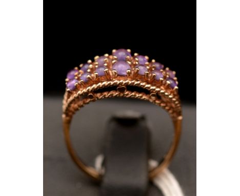 An amethyst ring, set with two rows of cabouchons, on 9ct gold shank.