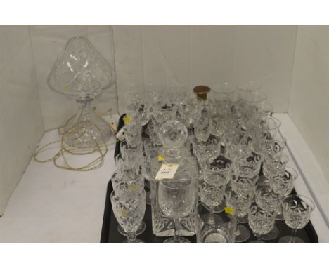 A large quantity of cut drinking glasses, a decanter, a scent bottle and a cut glass table lamp with shade.