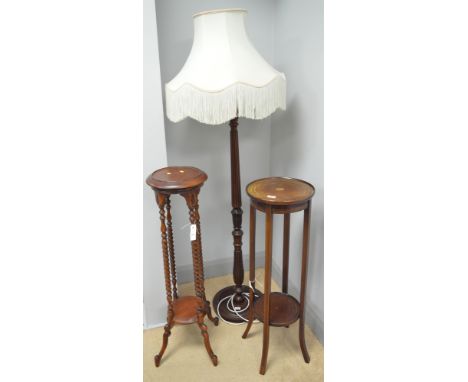 An Edwardian circular inlaid mahogany two-tier plant stand; a reproduction stained wood two-tier plant stand; and a mahogany 