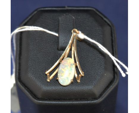 A white opal and yellow metal pendant, in modern pendant mount, stamped 9ct.