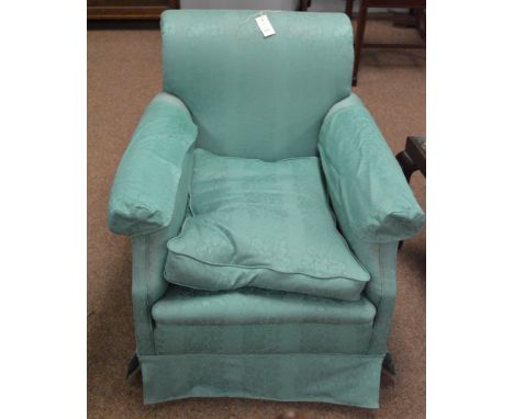 A single armchair with turquoise loose cover and loose seat cushion.