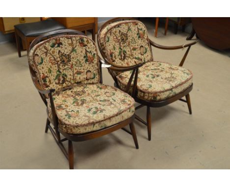 A pair of mid/late 20th Century Ercol open arm easy chairs, with loose seat and back cushions.