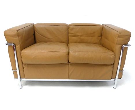 After a design by Le Corbusier for Cassina - an LC2 sofa, tubular chrome framed with tan leather cushioned upholstery, label 