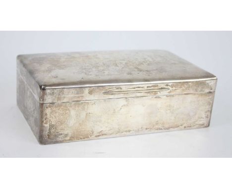 An Art Deco silver table cigar box, of rounded rectangular form with slightly domed hinged cover, the cedar lined gilt-washed