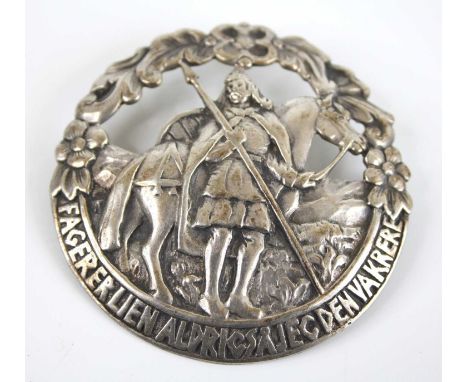 An early 20th century Norwegian silver Scandinavian Saga pin brooch, of stylised pierced circular form depicting 10th century