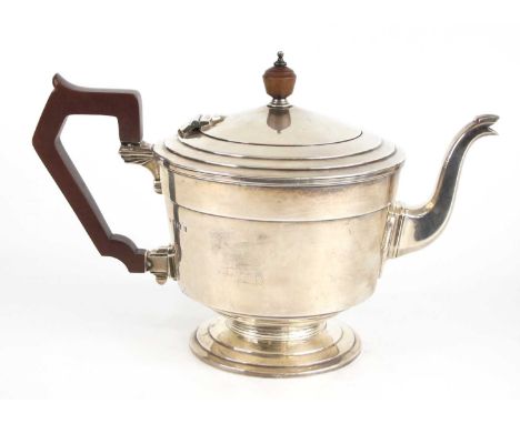 An Art Deco silver teapot, of squat circular urn form with stepped domed hinged cover and stepped pedestal foot, having angul