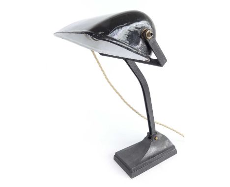 A 1930s painted iron industrial desk lamp, with enamelled domed hinged shade and raised on curved support to faceted base, h.