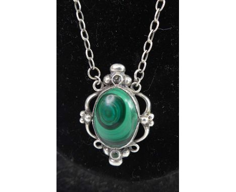 Georg Jensen - a silver and malachite cabochon inset model No. 21 pendant, of oval form with openwork surround, stamped marks