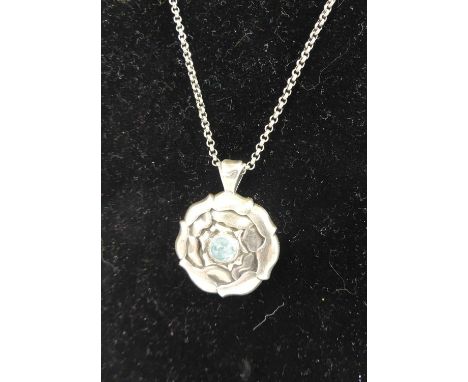 Ole Kortzau for Georg Jensen - a sterling silver and blue topaz cabochon inset flower head pendant, stamped marks verso, hous