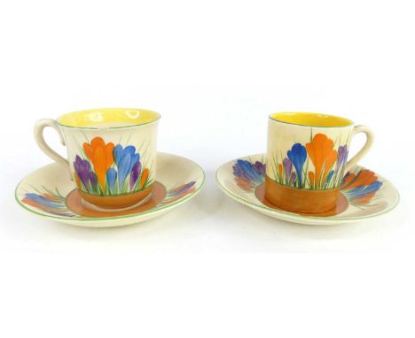A 1930s Clarice Cliff Crocus pattern pottery teacup and saucer, together with matching coffee can and saucer, each with black
