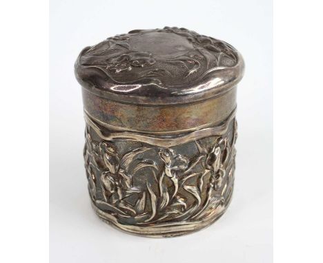 An Art Nouveau silver cylindrical canister and cover, having all-over embossed floral stylised decoration, the slightly domed