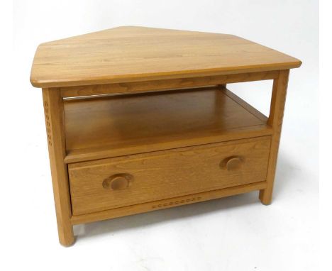 A contemporary Ercol blond elm 'Model 1130' corner media unit, having rear dropflap corner surface, open compartment over sin