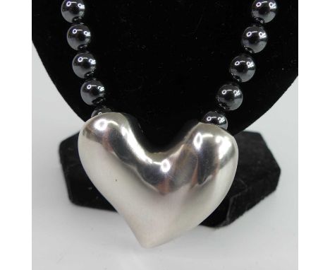 Georg Jensen - a sterling silver heart shaped pendant, of brushed texture, stamped marks to include 'No.247B', housed on a st
