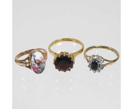 A large 9 carat garnet single stone ring, 2.9g, size O, together with a 9 carat gold cluster ring, 1.7g and a 9 carat gold dr