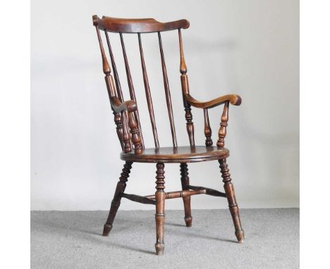 A Victorian stick back armchair, on turned legs