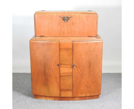 A 1930's walnut drinks cabinet, with a fitted interior92w x 35d x 117h cm