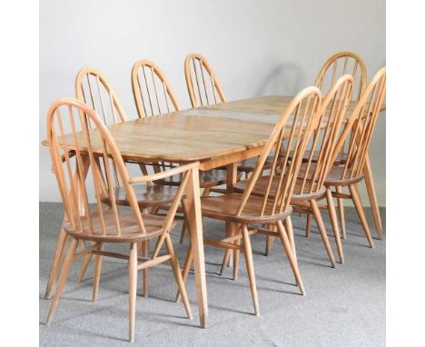 A 1960's Ercol light elm dining table, with an additional leaf, together with a set of eight dining chairs (9)222w x 83d x 71