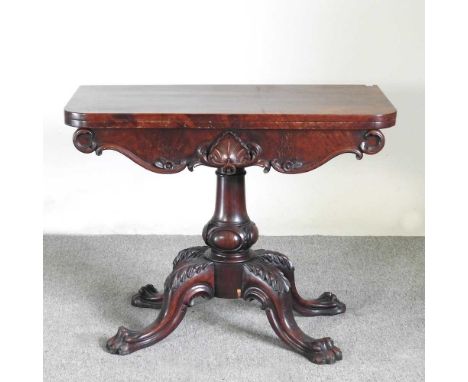 A William IV carved mahogany folding card table, on a scrolled base91w x 46d x 71h cm