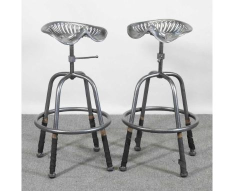 A pair of metal painted tractor seat bar stools (2)