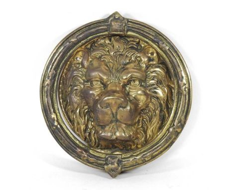 A large brass lion mask door knocker, 22cm diameter