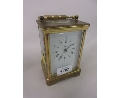 Brass cased carriage clock with enamel dial, Arabic and Roman numerals, signed Angelus with a single train key wind movement