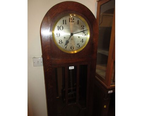 Oak longcase clock circa 1930 with dome shaped case and bun feet