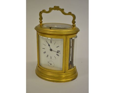 19th Century French matt gilded brass cased carriage clock of oval form, the enamel dial with Roman numerals and subsidiary a