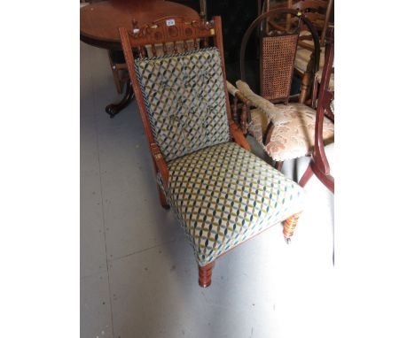 Late Victorian satin birch button upholstered low seat drawing room chair on turned front supports together with a Victorian 