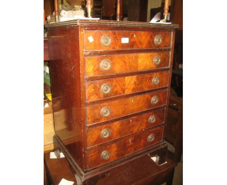 20th Century narrow mahogany chest with a reeded top above six drawers, brass ring handles and bracket feet