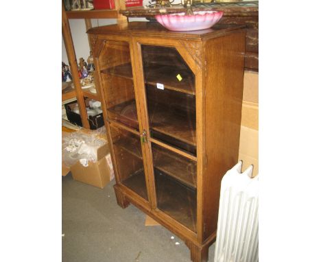 Small oak bookcase circa 1930 with two bevelled glass doors on bracket feet