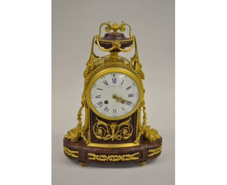19th Century French rouge marble and ormolu mounted mantel clock by Raingo Frères, the enamel dial with Arabic and Roman nume