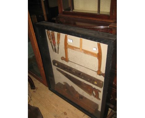 Boxed display case housing a small collection of various woodworking tools