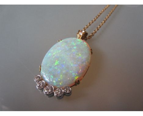 Large 18ct gold mounted oval opal pendant with five graduated diamonds suspended from a 9ct gold chain