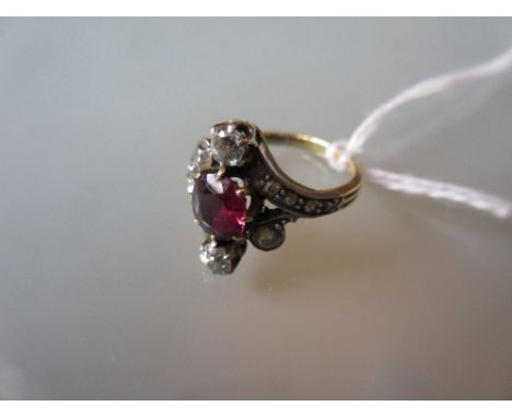 Pink ruby and diamond set crossover ring of stylised floral design