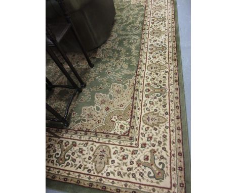 Machine woven Persian design carpet with medallion and floral design on a green ground, 12ft x 9ft approximately