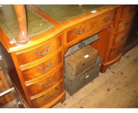 Reproduction yew wood twin pedestal desk with a three section leather inset top above nine drawers on bracket feet