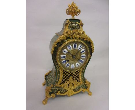 Late 19th Century French green stained tortoiseshell and cut brass inlaid buhl mantel clock of waisted form with a vase of fl