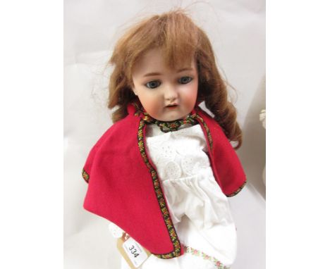 Simon & Halbig bisque headed doll having closing eyes and fully jointed body, marked WSK4, with lace dress and cloak