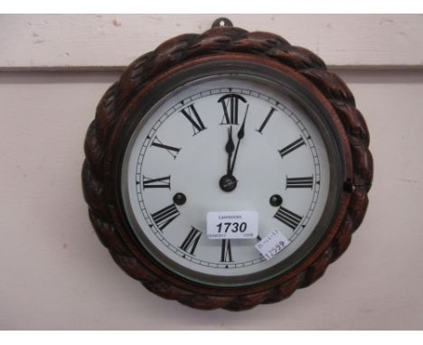 Circular carved oak rope pattern wall clock, the enamel dial with Roman numerals, with a two train Seth Thomas chronometer mo