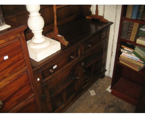 Reproduction oak dresser with a boarded shelf back above two drawers and two panelled doors on stile feet