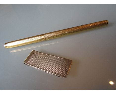 Dunhill gold plated fountain pen together with a silver Dunhill money clip with engine turned decoration