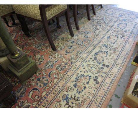 Late 20th Century Sarouk carpet with a medallion and all-over stylised floral design on a rose ground with borders, 14ft x 9f