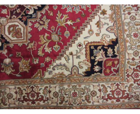 Machine made Heriz pattern carpet on red ground, 2.3m x 1.6m