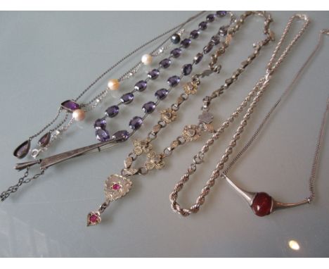 Five various silver pendant necklaces, silver neck chain and a dagger form bar brooch