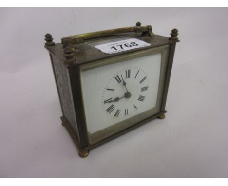 Small brass cased carriage clock with enamel dial and Roman numerals (crack to dial)
